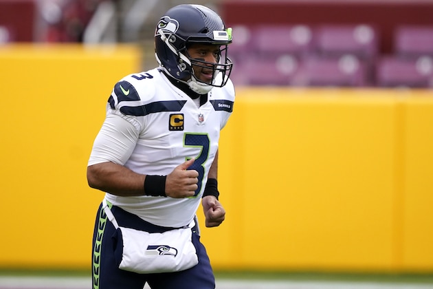 Seattle Seahawks quarterback Russell Wilson runs on the field prior to an NFL football game between the Seattle Seahawks and the Washington Football Team, Sunday, Dec. 20, 2020, in Landover, Md. (AP Photo/Mark Tenally)