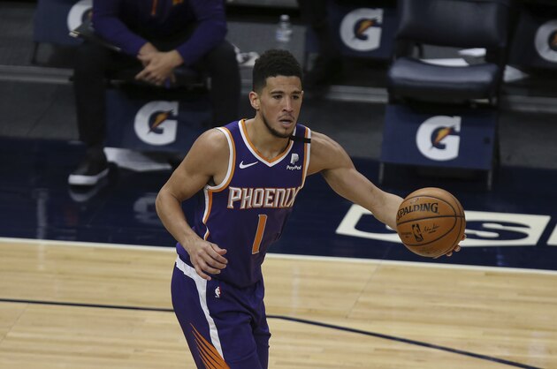 Phoenix Suns' Devin Booker (1) handles the ball in the first half of an NBA basketball game against the Minnesota Timberwolves, Sunday, Feb. 28, 2021, in Minneapolis. (AP Photo/Stacy Bengs)
