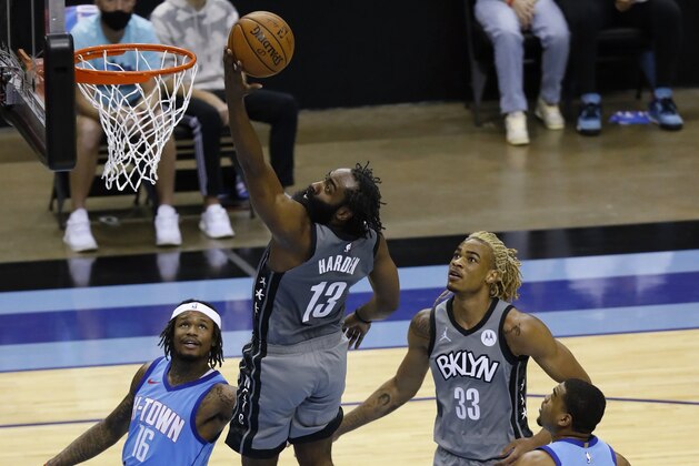 Brooklyn Nets' James Harden drives to basket for a layup past Houston Rockets' Ben McLemore, left, during the second quarter of an NBA basketball game Wednesday, March 3, 2021, in Houston. (Bob Levey/Pool Photo via AP)