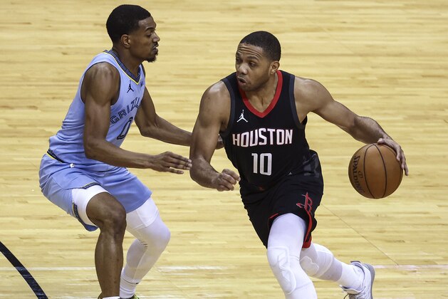 Houston Rockets guard Eric Gordon (10) dribbles the ball as Memphis Grizzlies guard De'Anthony Melton (0) defends during the second quarter of an NBA basketball game Sunday, Feb. 28, 2021, in Houston. (Troy Taormina/Pool Photo via AP)