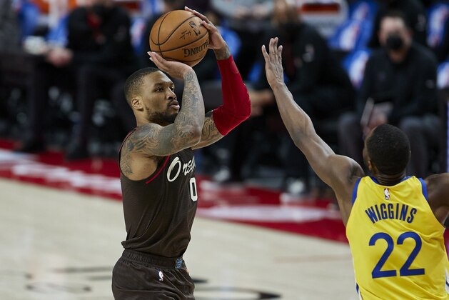 Portland Trail Blazers guard Damian Lillard shoots a 3-point basket over Golden State Warriors forward Andrew Wiggins during the second half of an NBA basketball game in Portland, Ore., Wednesday, March 3, 2021. (AP Photo/Craig Mitchelldyer)