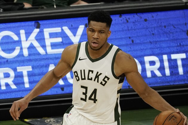 Milwaukee Bucks' Giannis Antetokounmpo dribbles during the second half of an NBA basketball game against the Denver Nuggets Tuesday, March 2, 2021, in Milwaukee. (AP Photo/Morry Gash)