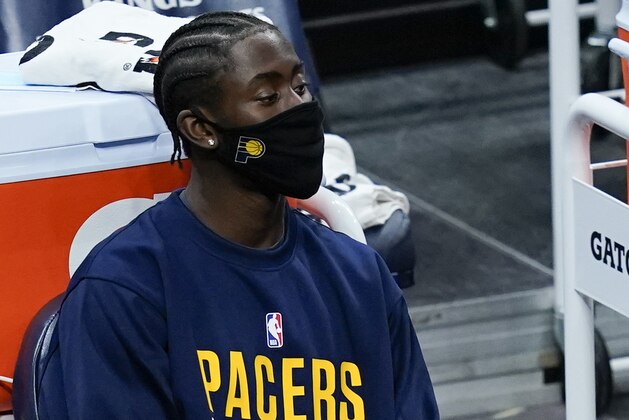 Indiana Pacers' Caris LeVert watches from the bench during the first half of an NBA basketball game against the Dallas Mavericks, Wednesday, Jan. 20, 2021, in Indianapolis. (AP Photo/Darron Cummings)