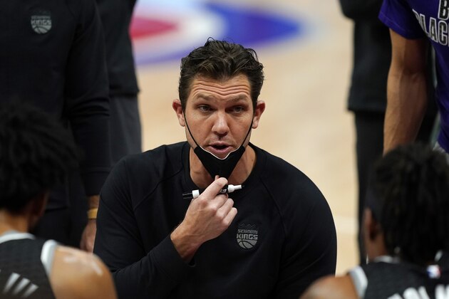 Sacramento Kings head coach Luke Walton talks to the team during a timeout in the first half of an NBA basketball game against the Detroit Pistons, Friday, Feb. 26, 2021, in Detroit. (AP Photo/Carlos Osorio)