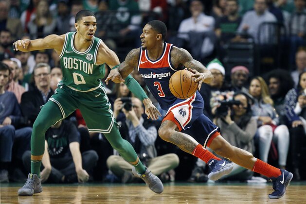 Washington Wizards' Bradley Beal (3) drives past Boston Celtics' Jayson Tatum (0) during the first quarter of an NBA basketball game in Boston, Monday, Dec. 25, 2017. (AP Photo/Michael Dwyer)