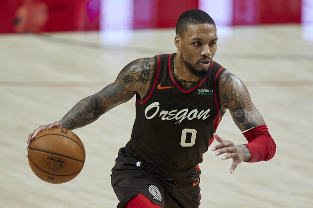 Portland Trail Blazers guard Damian Lillard brings the ball up court against the Golden State Warriors during the first half of an NBA basketball game in Portland, Ore., Wednesday, March 3, 2021. (AP Photo/Craig Mitchelldyer)