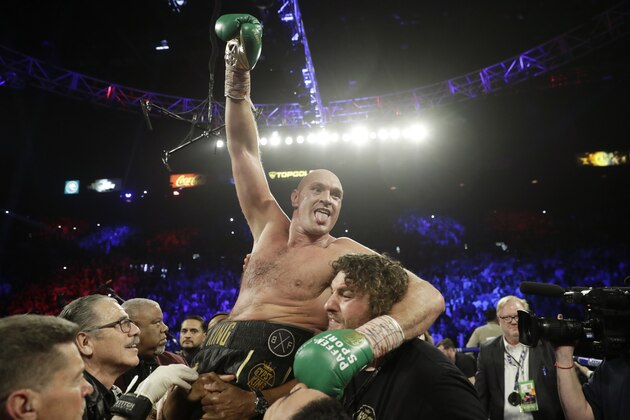 FILE - In this Saturday, Feb. 22, 2020 file photo, Britain's Tyson Fury, celebrates after defeating Deontay Wilder in a WBC heavyweight championship boxing match in Las Vegas. Fury says he plans to fight in London on Dec. 5 but his opponent is unknown. Fury says in a video message posted on his social media accounts that he's “definitely fighting December the 5th in London” and that the opponent will be announced “very, very soon.” Fury and his co-promoter Frank Warren recently expressed doubt that a third fight with American Deontay Wilder would happen in 2020. (AP Photo/Isaac Brekken, File)
