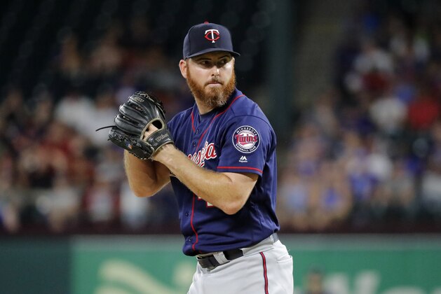 Minnesota Twins relief pitcher Sam Dyson throws to the Texas Rangers in a baseball game in Arlington, Texas, Friday, Aug. 16, 2019. (AP Photo/Tony Gutierrez)