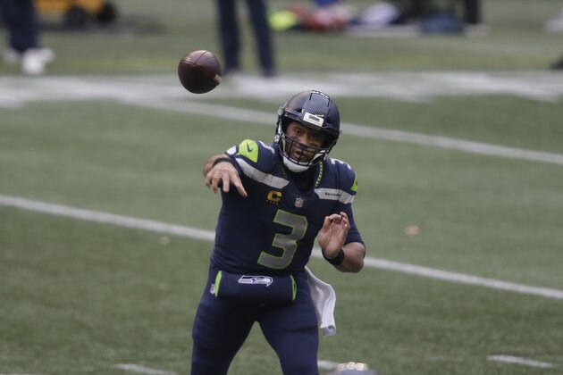 Seattle Seahawks quarterback Russell Wilson in action against the Los Angeles Rams during the first half of an NFL wild-card playoff football game, Saturday, Jan. 9, 2021, in Seattle. (AP Photo/Scott Eklund)