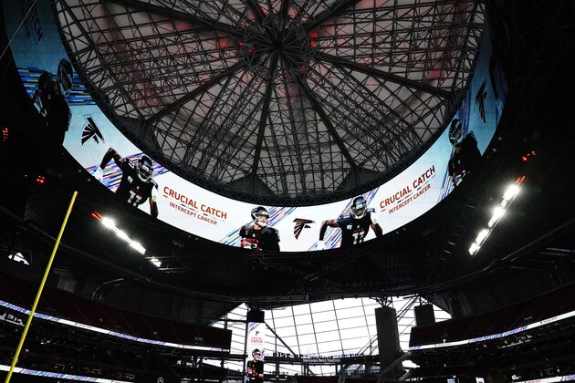 Crucial Catch signs are shown on the banner inside the Mercedes-Benz Stadium during the second half of an NFL football game between the Atlanta Falcons and the Carolina Panthers, Sunday, Oct. 11, 2020, in Atlanta. (AP Photo/Brynn Anderson)
