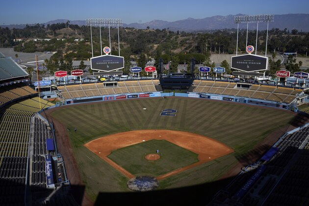 A No. 2 is painted on the outfield grass in honor of Tommy Lasorda at Dodger Stadium Friday, Jan. 8, 2021, in Los Angeles. Tommy Lasorda, the fiery Hall of Fame manager who guided the Los Angeles Dodgers to two World Series titles and later became an ambassador for the sport he loved during his 71 years with the franchise, has died. He was 93. (AP Photo/Marcio Jose Sanchez)