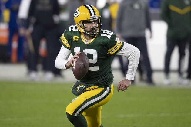 Green Bay Packers quarterback Aaron Rodgers (12) in action during an NFL divisional playoff football game between the Los Angeles Rams and Green Bay Packers, Saturday, Jan. 16, 2021, in Green Bay, Wis. (AP Photo/Jeffrey Phelps)