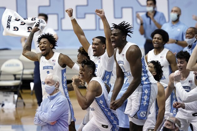 North Carolina players celebrate a victory in an NCAA college basketball game against Duke in Chapel Hill, N.C., Saturday, March 6, 2021. (AP Photo/Gerry Broome)