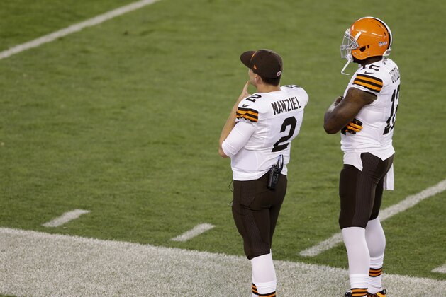 Cleveland Browns quarterback Johnny Manziel, left, watches form the sidelines with Josh Gordon during a preseason NFL football game Saturday, Aug. 23, 2014, in Cleveland. (AP Photo/Tony Dejak)