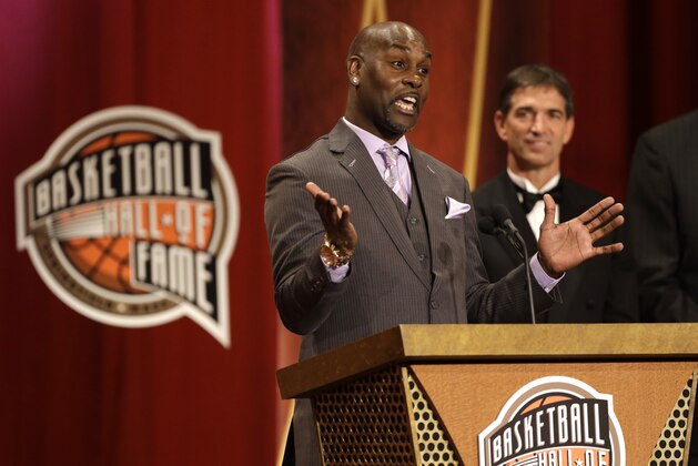 Inductee Gary Payton, left, speaks during the enshrinement ceremony for the 2013 class of the Naismith Memorial Basketball Hall of Fame as Hall of Famer John Stockton, right, looks on at Symphony Hall in Springfield, Mass., Sunday, Sept. 8, 2013. (AP Photo/Steven Senne)