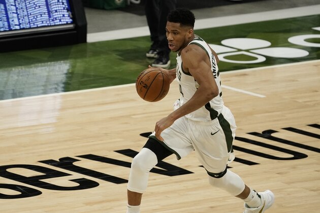Milwaukee Bucks' Giannis Antetokounmpo dribbles during the second half of an NBA basketball game against the Denver Nuggets Tuesday, March 2, 2021, in Milwaukee. (AP Photo/Morry Gash)