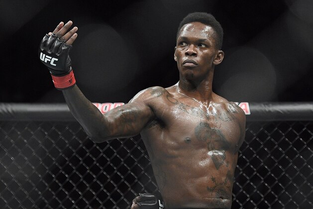 FILE - In this Feb. 10, 2019, file photo, Nigeria's Israel Adesanya poses as he fights Brazil's Anderson Silva in their middleweight bout at the UFC 234 mixed martial arts fights in Melbourne, Australia. Adesanya challenges champion Jan Blachowicz of Poland for the light heavyweight title in the main event of UFC 259 on Saturday in Las Vegas.  (AP Photo/Andy Brownbill, File)