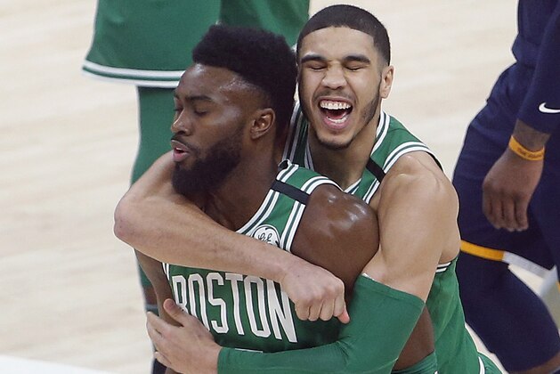 Boston Celtics' Jayson Tatum, rear, hugs Jaylen Brown, left, after Brown scored the winning 3-pointer against the Utah Jazz during an NBA basketball game Wednesday, March 28, 2018, in Salt Lake City. The Celtics won 97-94. (AP Photo/Rick Bowmer)