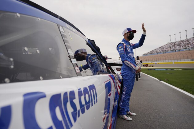 Kyle Larson waves as he is introduced before a NASCAR Cup Series auto race Sunday, March 7, 2021, in Las Vegas. (AP Photo/John Locher)