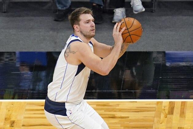 Dallas Mavericks guard Luka Doncic looks to shoot against the Orlando Magic during the first half of an NBA basketball game, Monday, March 1, 2021, in Orlando, Fla. (AP Photo/John Raoux)