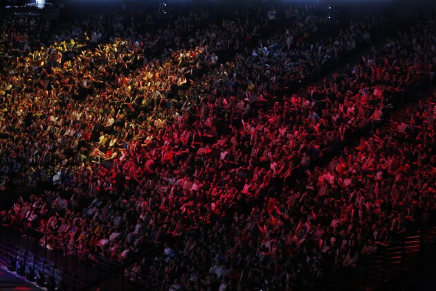 Spectators watch the final of League of Legends tournament between Team G2 Esports and Team FunPlus Phoenix, in Paris, Sunday, Nov. 10, 2019. The biggest e-sports event of the year saw a Chinese team, FunPlus Phoenix, crowned as world champions of the video game League of Legends. Thousands of fans packed a Paris arena for the event, which marked another step forward for the growing esports business. (AP Photo/Thibault Camus)