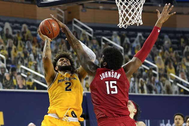 Rutgers center Myles Johnson (15) blocks a Michigan Wolverines forward Isaiah Livers (2) shot in the second half of an NCAA college basketball game in Ann Arbor, Mich., Thursday, Feb. 18, 2021. (AP Photo/Paul Sancya)