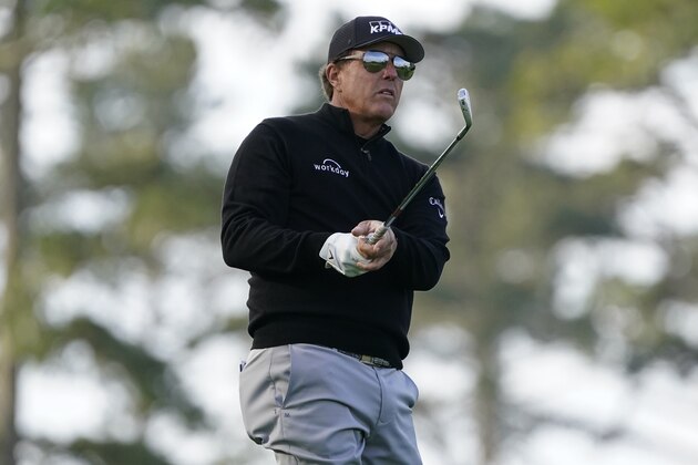 Phil Mickelson follows his approach shot to the 10th green of the Spyglass Hill Golf Course during the first round of the AT&T Pebble Beach Pro-Am golf tournament, Thursday, Feb. 11, 2021, in Pebble Beach, Calif. (AP Photo/Eric Risberg)