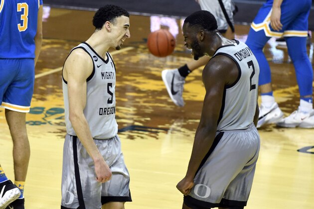 Oregon guard Chris Duarte (5) and forward Eugene Omoruyi (2) celebrate after the team's NCAA college basketball game against UCLA on Wednesday, March 3, 2021, in Eugene, Ore. (AP Photo/Andy Nelson)