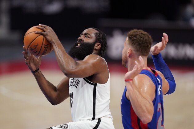 Brooklyn Nets guard James Harden makes a layup as Detroit Pistons forward Blake Griffin defends during the first half of an NBA basketball game, Tuesday, Feb. 9, 2021, in Detroit. (AP Photo/Carlos Osorio)