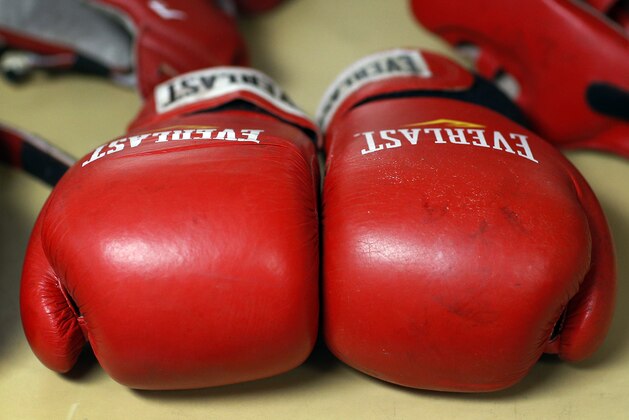 Boxing gloves lay on a table during the Brigade Boxing Championships at the U.S. Naval Academy in Annapolis, Md., Friday, Feb. 28, 2014. The academy has offered boxing since 1865, both as a club sport as well as a required part of the physical education program. (AP Photo/Patrick Semansky)