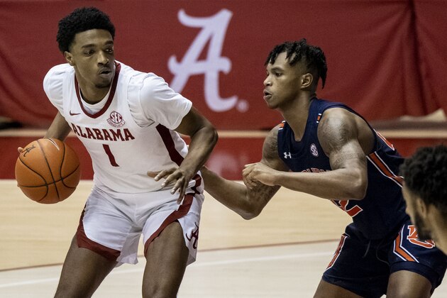 Alabama forward/guard Herbert Jones (1) works inside against Auburn guard Allen Flanigan (22) during the second half of an NCAA college basketball game, Tuesday, March 2, 2021, in Tuscaloosa, Ala. (AP Photo/Vasha Hunt)