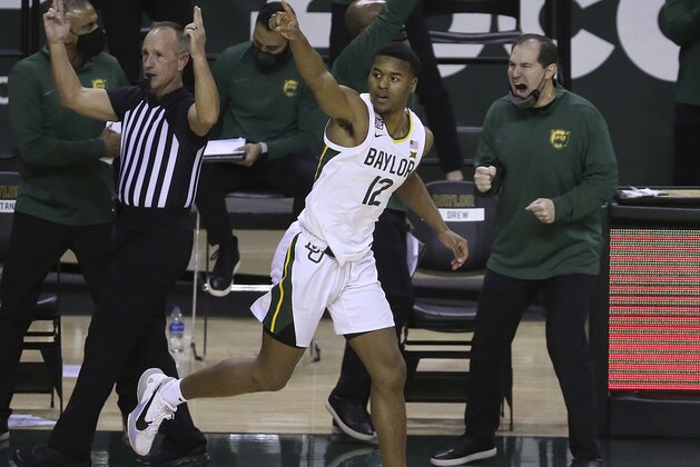 Baylor guard Jared Butler (12) reacts after score a three point shot against Oklahoma State in the second half of an NCAA college basketball game, Thursday, March 4, 2021, in Waco, Texas. (AP Photo/Jerry Larson)