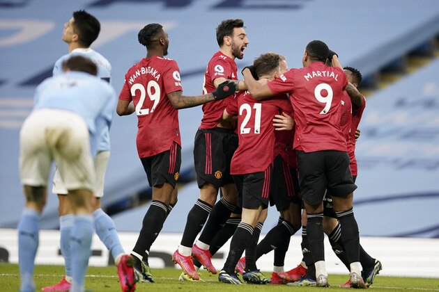 Manchester United players celebrate after scoring their second goal during the English Premier League soccer match between Manchester City and Manchester United at the Etihad Stadium in Manchester, England, Sunday, March 7, 2021. (Dave Thompson/Pool via AP)
