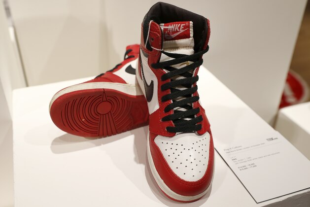 A pair of Nike Sky Jordan 1, 1985 with Chicago Bulls White, Black and Red colourway at Bonhams auction house, part of the Pop Culture sale in London, Thursday, Oct. 1, 2020. This pair is estimated at 14,000-16,000 UK pounds (18,000-20,000 US dollars, when sold in the auction on Oct. 8. (AP Photo/Alastair Grant)