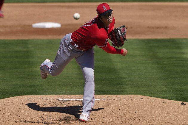 Los Angeles Angels pitcher Shohei Ohtani (17) throws against the Oakland Athletics during the first inning of a spring training baseball game, Friday, March 5, 2021, in Mesa, Ariz. (AP Photo/Matt York)