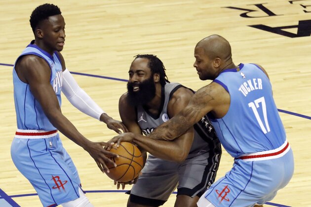 Brooklyn Nets' James Harden (13) is pressured by Houston Rockets' P.J. Tucker (17) and Victor Oladipo (7) during the first half of an NBA basketball game Wednesday, March 3, 2021, in Houston. (Bob Levey/Pool Photo via AP)