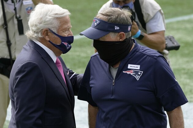 New England Patriots owner Robert Kraft, left, speaks to head coach Bill Belichick before an NFL football game against the Las Vegas Raiders, Sunday, Sept. 27, 2020, in Foxborough, Mass. Belichick wore a patch honoring Fritz Pollard, the first African American head coach in the American Professional Football Association, renamed the National Football League, in 1921 for the Akron Pros. (AP Photo/Charles Krupa)