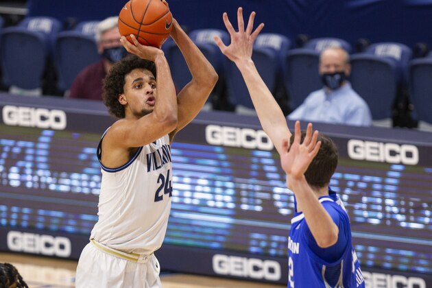Villanova forward Jeremiah Robinson-Earl (24) shoots over Creighton center Ryan Kalkbrenner (32) during the first half of an NCAA college basketball game Wednesday, March 3, 2021, in Villanova, Pa. (AP Photo/Laurence Kesterson)