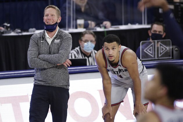 Gonzaga head coach Mark Few, left, speaks with guard Jalen Suggs during the second half of an NCAA college basketball game against Pacific in Spokane, Wash., Saturday, Jan. 23, 2021. (AP Photo/Young Kwak)