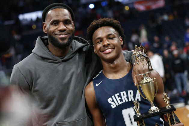 LeBron James, left, poses with his son Bronny after Sierra Canyon beat Akron St. Vincent - St. Mary in a high school basketball game, Saturday, Dec. 14, 2019, in Columbus, Ohio. (AP Photo/Jay LaPrete)
