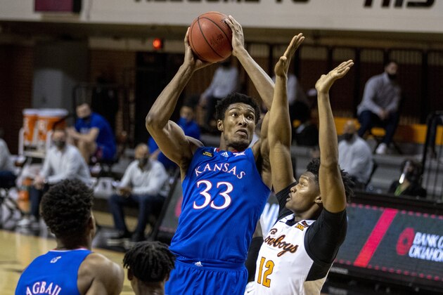 Kansas' David McCormack shoots over Oklahoma State's Matthew-Alexander Moncrieffe during the first half of an NCAA college basketball game in Stillwater, Okla., Tuesday, Jan. 12, 2021. (AP Photo/Mitch Alcala) Kansas' David McCormack shoots over Oklahoma State's Matthew-Alexander Moncrieffe during the first half of an NCAA college basketball game in Stillwater, Okla., Tuesday, Jan. 12, 2021. (AP Photo/Mitch Alcala)
