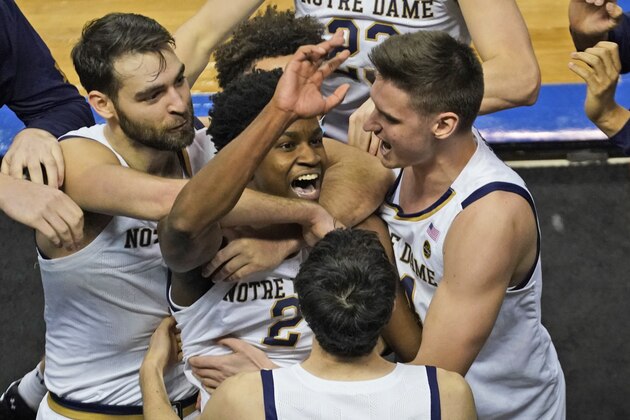 Notre Dame guard Trey Wertz (2) who sank the game winning shot is swarmed by teammates after their 80-77 win over Wake Forest in the first round of the Atlantic Coast Conference tournament in Greensboro, N.C., Tuesday, March 9, 2021. (AP Photo/Gerry Broome)