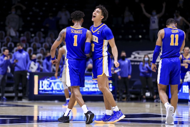 Xavier guard Paul Scruggs (1) celebrates with guard Colby Jones (3) during the second half of the team's NCAA college basketball game against Creighton, Saturday, Feb. 27, 2021, in Cincinnati. Xavier won 77-69. (AP Photo/Aaron Doster)