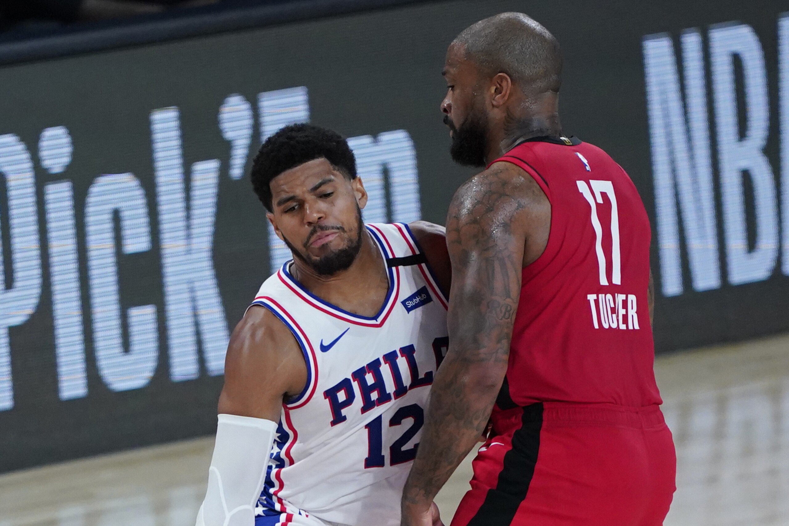 Philadelphia 76ers' Tobias Harris (12) drives into Houston Rockets' P.J. Tucker (17) during the first half of an NBA basketball game Friday, Aug. 14, 2020, in Lake Buena Vista, Fla. (AP Photo/Ashley Landis, Pool) Philadelphia 76ers' Tobias Harris (12) drives into Houston Rockets' P.J. Tucker (17) during the first half of an NBA basketball game Friday, Aug. 14, 2020, in Lake Buena Vista, Fla. (AP Photo/Ashley Landis, Pool)