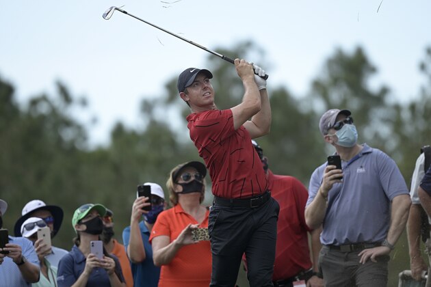 Rory McIlroy, of Northern Ireland, hits onto the seventh fairway from the rough along the third fairway during the final round of the Workday Championship golf tournament Sunday, Feb. 28, 2021, in Bradenton, Fla. McIlroy's tee shot on the seventh hole had landed on the adjacent hole. (AP Photo/Phelan M. Ebenhack)