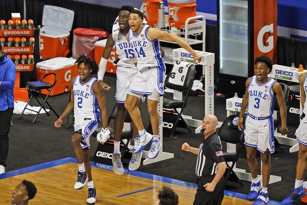 Duke center Mark Williams (15) guard DJ Steward (2) guard Jordan Goldwire (14) and guard Jeremy Roach (3) celebrate their 86-51 win over Boston College in the first round of the Atlantic Coast Conference tournament in Greensboro, N.C., Tuesday, March 9, 2021. (AP Photo/Gerry Broome)