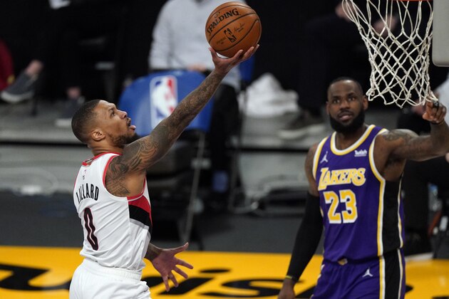 Portland Trail Blazers guard Damian Lillard (0) shoots against Los Angeles Lakers forward LeBron James (23) during the first half of an NBA basketball game Friday, Feb. 26, 2021, in Los Angeles. (AP Photo/Mark J. Terrill)