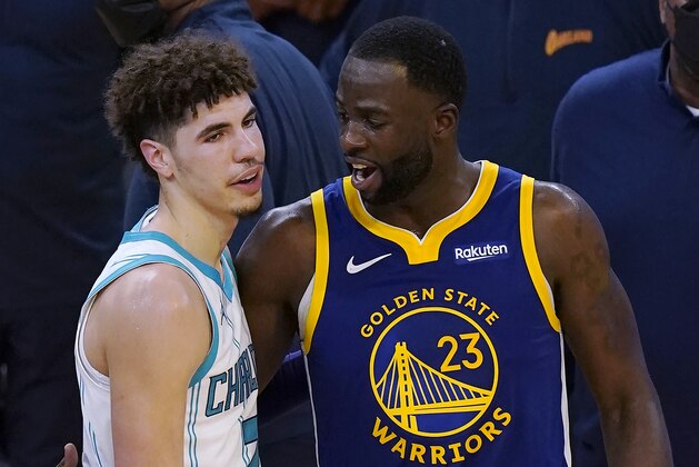 Charlotte Hornets guard LaMelo Ball, left, talks with Golden State Warriors forward Draymond Green after the Warriors defeated the Hornets in an NBA basketball game in San Francisco, Friday, Feb. 26, 2021. (AP Photo/Jeff Chiu)