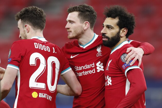 Liverpool's Mohamed Salah, right, celebrates after scoring his side's opening goal during the Champions League round of 16 second leg soccer match between Liverpool and RB Leipzig at the Puskas Arena stadium in Budapest, Hungary, Wednesday, March 10, 2021. (AP Photo/Laszlo Balogh)