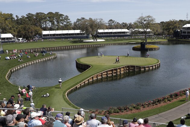 Cameron Champ, Nate Lashley, Kevin Tway and their caddies, walk the 17th green, during the first round of The Players Championship golf tournament Thursday, March 12, 2020 in Ponte Vedra Beach, Fla. (AP Photo/Lynne Sladky)